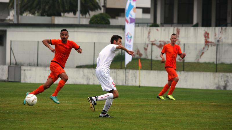 Football player on field of play waits for the ball to be passed