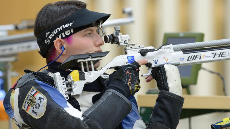 A female German shooter preparing for the next shot.