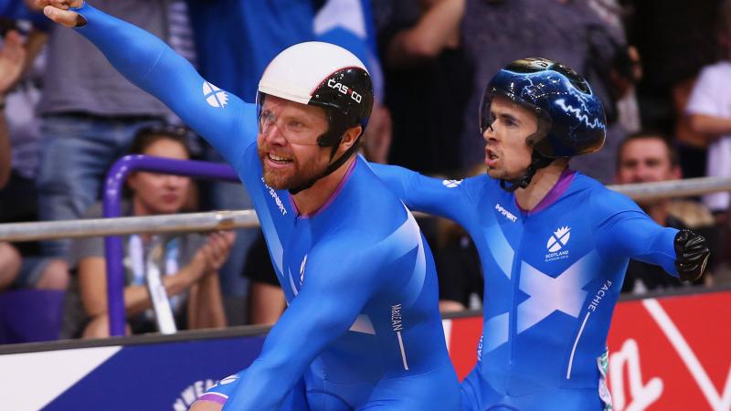 Scotland's Neil Fachie and co-pilot Craig MacLean celebrate their para-cycling victory at the Glasgow 2014 Commonwealth Games.