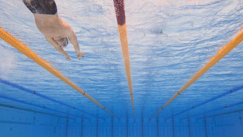 A swimmer begins a race at London 2012