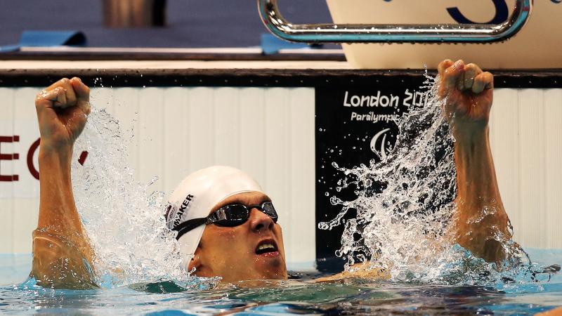 A swimmer clenches his fists in delight after winning gold at London 2012.