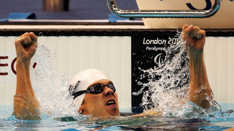 A swimmer clenches his fists in delight after winning gold at London 2012.