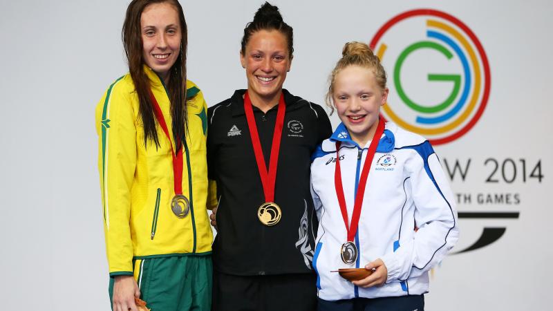New Zealand's gold medallist Sophie Pascoe with silver medallist Madeleine Scott of Australia and bronze medallist Erraid Davies of Scotland during the medal ceremony for the Women's 100m Breaststroke SB9 Final at Glasgow 2014