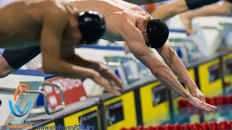 Male swimmers start a race at the 2014 IPC Swimming European Championships