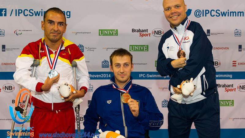 Dmytro Vynohradets poses with his latest gold medal alongside the silver and bronze medal winners at the 2014 IPC Swimming European Championships.