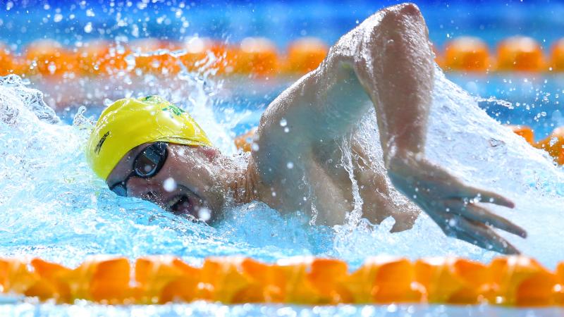 Australia's Daniel Fox in a yellow swim cap swimming freestyle