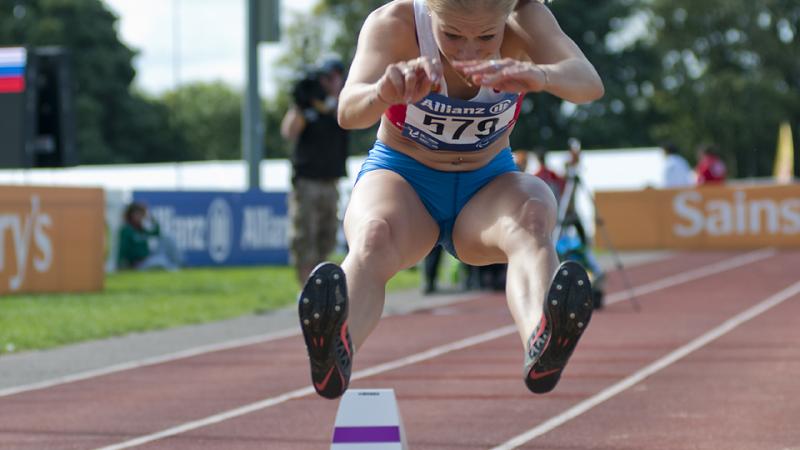 Women doing long jump shortly before the landing