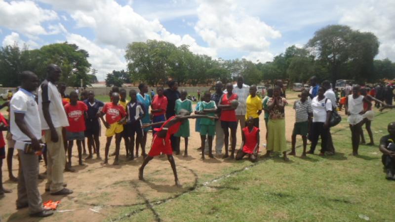 A young Ugandan tries out shot-put