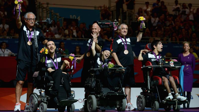 Pieter Cilissen, Kirsten De Laender and Pieter Verlinden of Belgium celebrate winning bronze in the Mixed Pairs Boccia - BC3 at the London 2012 Paralympic Games.