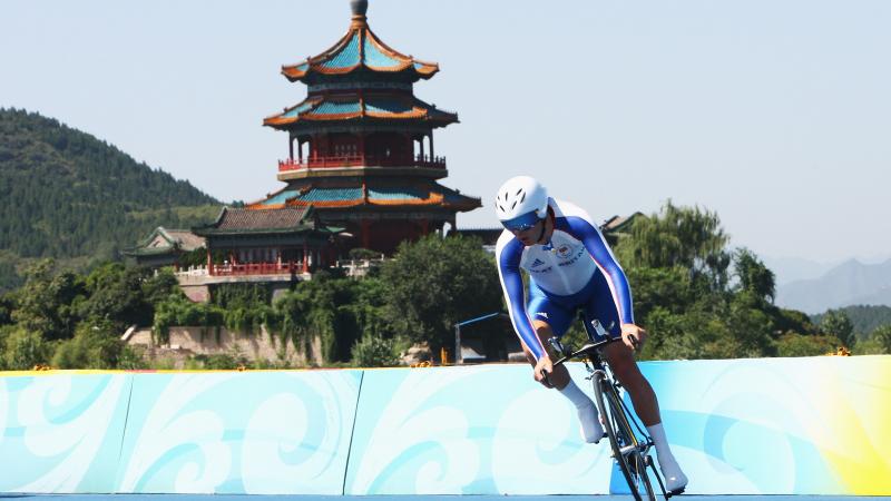 Cyclist in front of the forbidden city during the Beijing 2008 Paralympic Games.