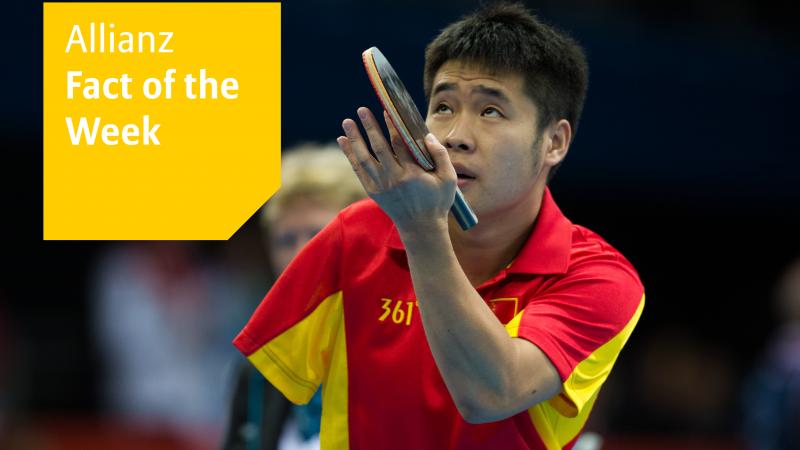 A one-armed Chinese table tennis player about to serve, watching the ball.