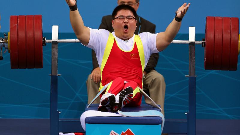 Gu Xiaofei, China, celebrating his lift, lifting up his arms.