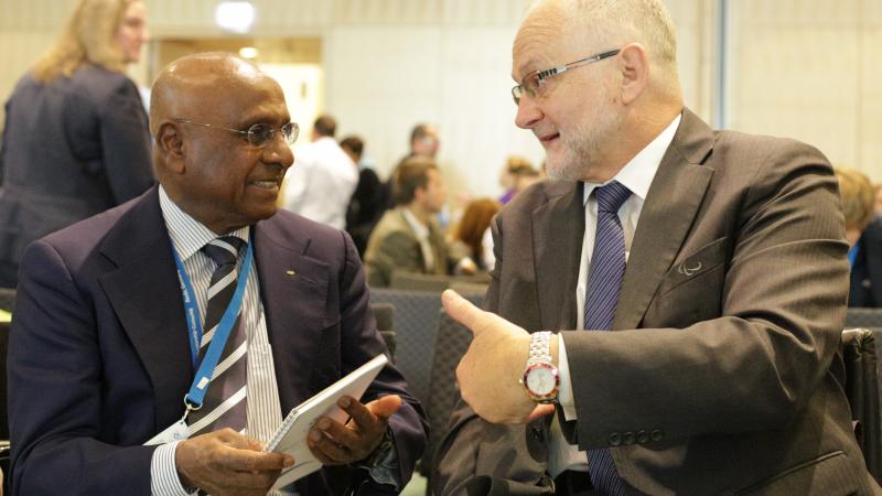 Sam Ramsamy and Sir Philip Craven talking and smiling 