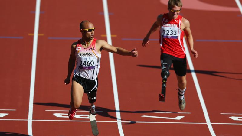 Atsushi Yamamoto of Japan and Daniel Jorgensen of Denmark compete in the men's 100m T42 heats at London 2012