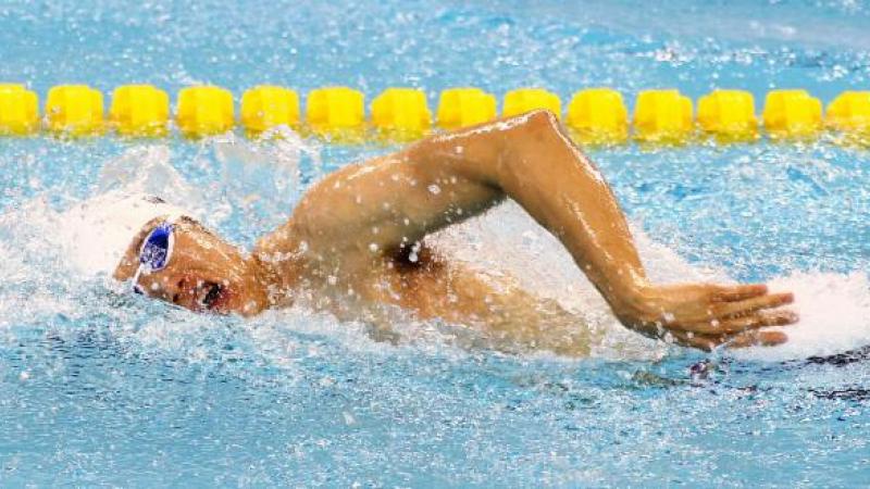 Swimmer in the water taking a breath in freestyle