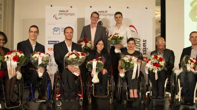 athletes holding flowers facing the camera