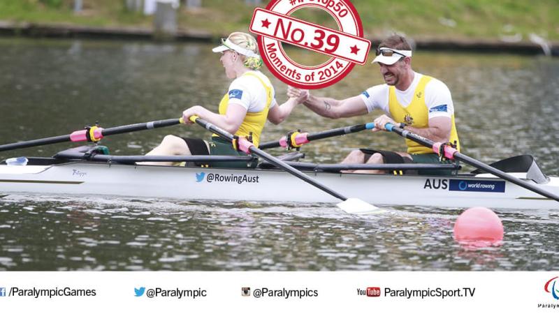 Kathryn Ross and Gavin Bellis hold hands in celebration in boat