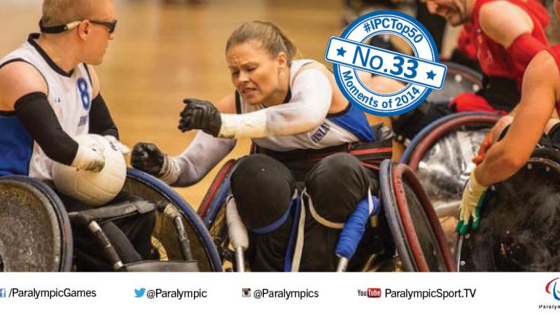 Picture of a female wheelchair rugby player fighting for the ball.