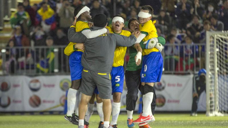 Blindefolded football team celebrating