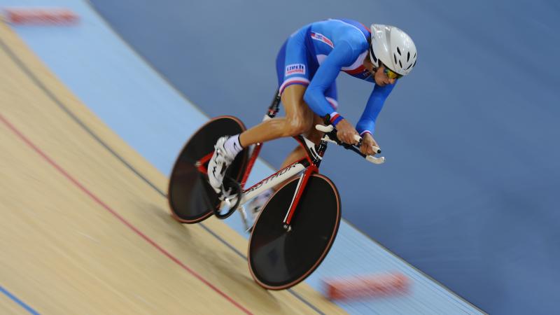 Man on a bike in racing suit, racing on a track