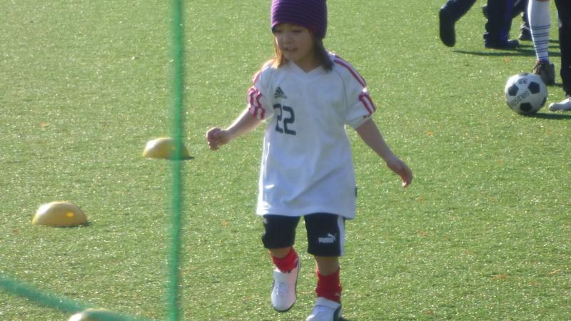 Little girls plays with football