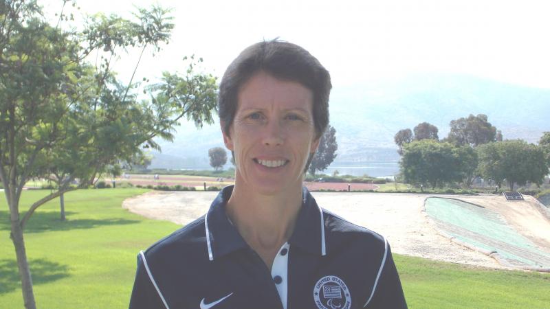 Portrait picture of a women in Team USA uniform in front of a landscape