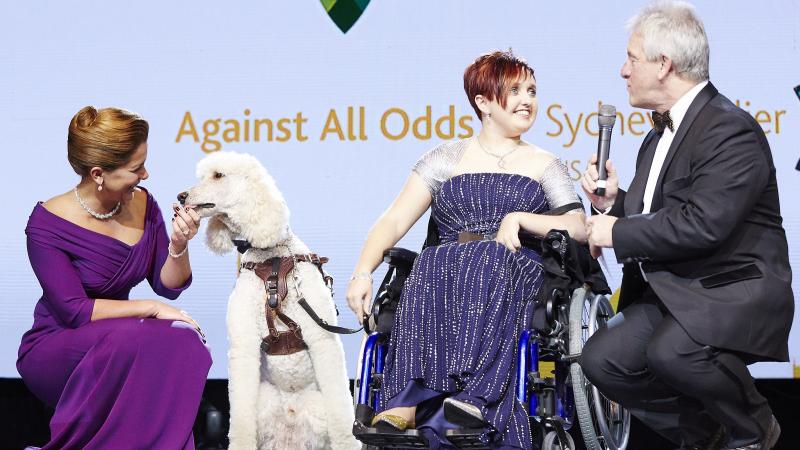 Sydney Collier and her service dog Journey receive the 2014 FEI Against All Odds award.