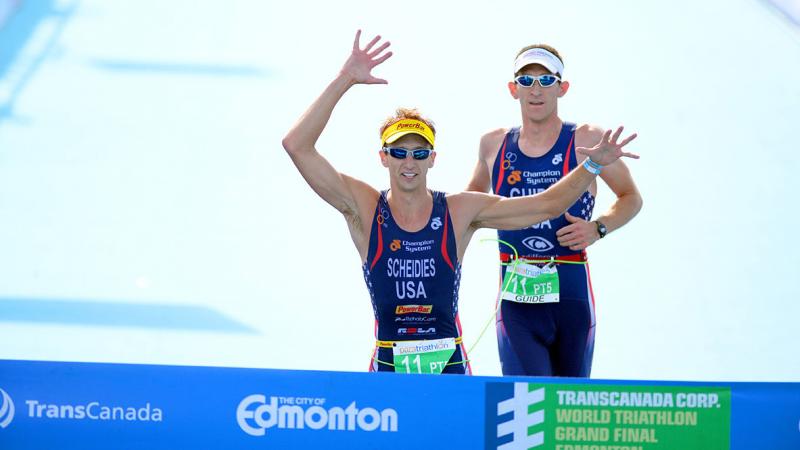 Aaron Scheidies crosses the finish line with his guide at a race in Edmonton.