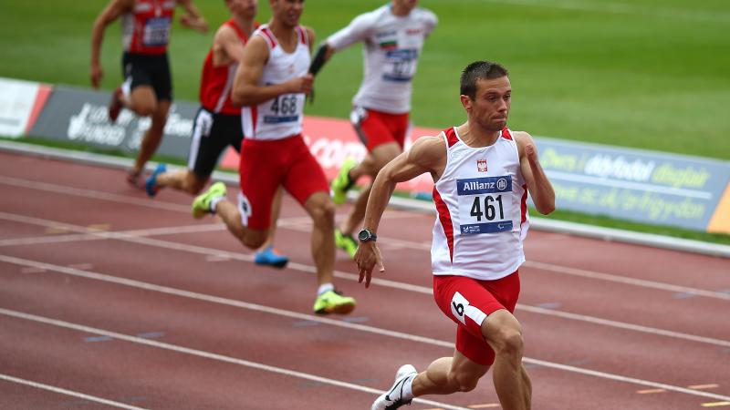 Group of men sprinting on a track