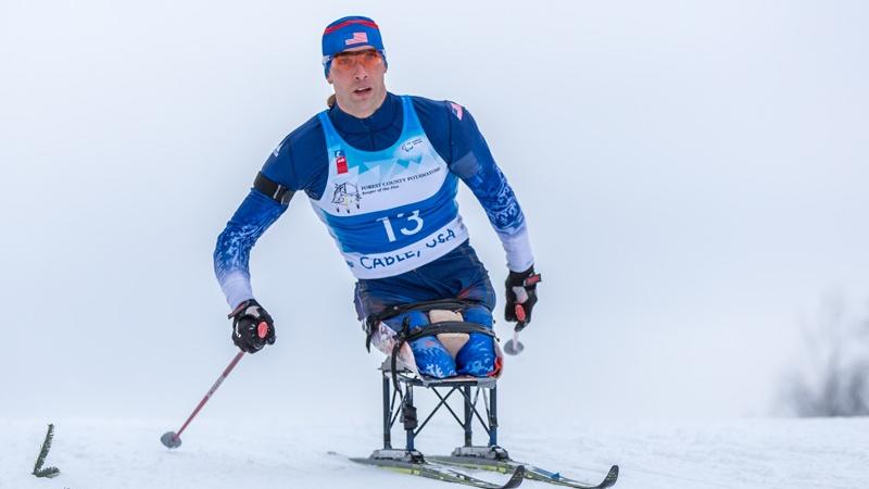 Man in sit ski doing cross country skiing 