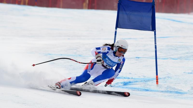 A female standing skier competes in super-G