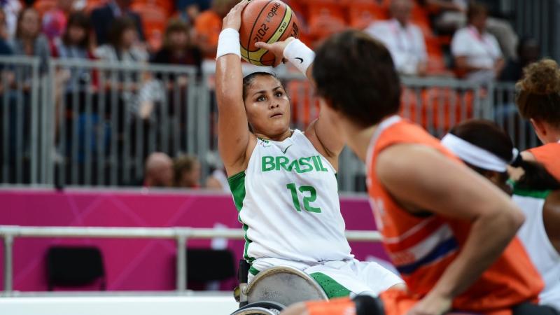 women in wheelchair saves the basketball