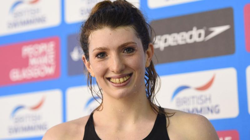 A swimmer smiles having won gold and set a new world record