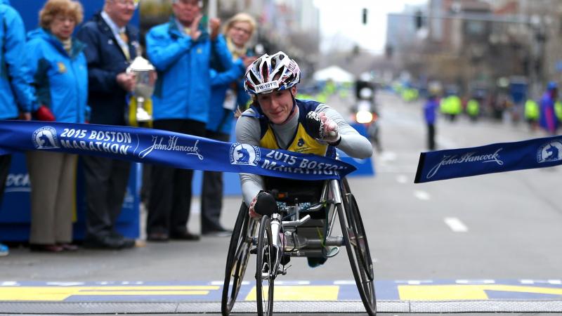 Tatyana McFadden of the United States crosses the finish line to win the women's push rim wheelchair division of the 119th Boston Marathon on April 20, 2015 in Boston, Massachusetts.