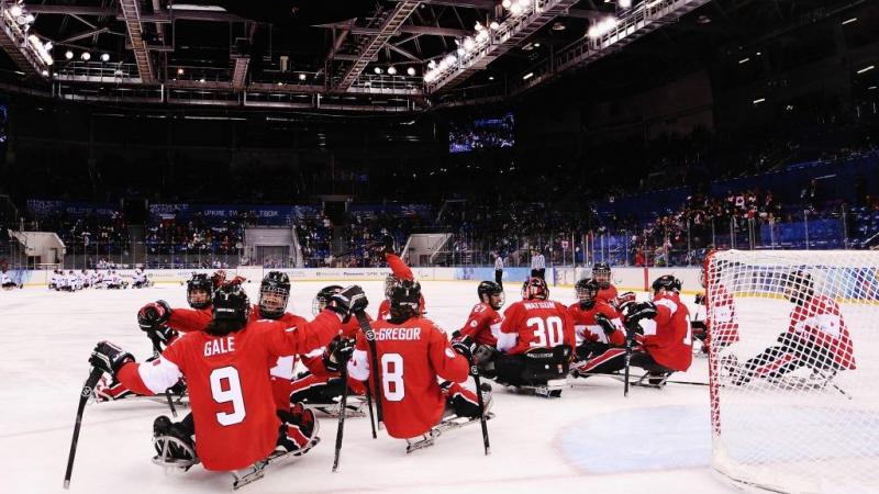Canada players celebrate after the ice sledge hockey bronze medal game between Canada and Norway at the Shayba Arena at the 2014 Paralympic Winter Games.