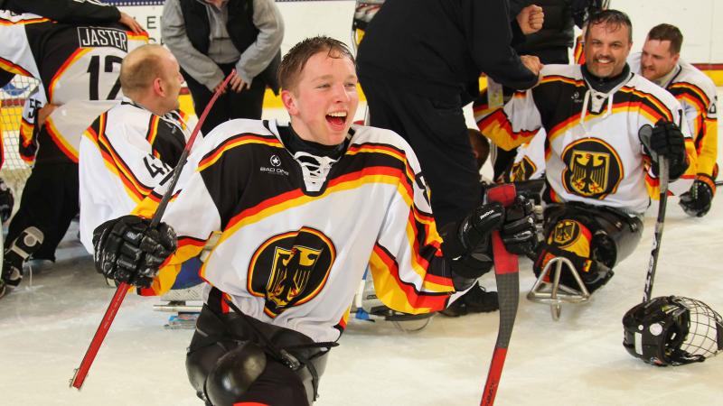 German sledge hockey player cheering.