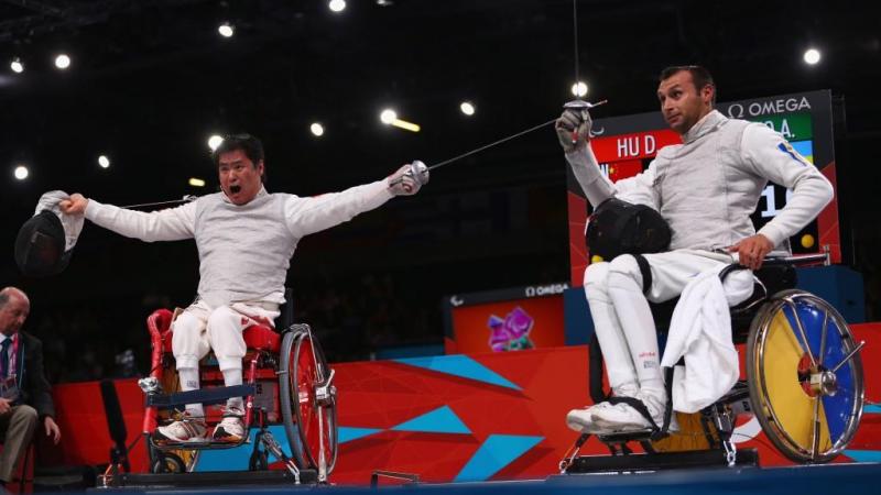 Daoliang Hu (L) of China celebrates winning gold against Anton Datsko (R) of Ukraine during the Men's Individual Foil Category B final of the Wheelchair Fencing on day 6 of the London 2012 Paralympic Games.
