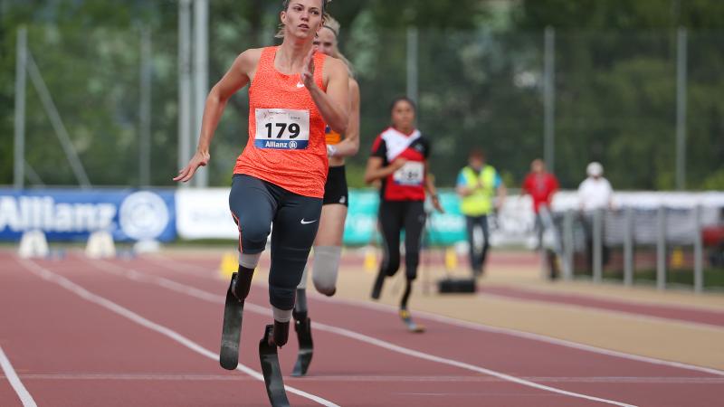 A blade runner crossers the finish line ahead of her rivals.