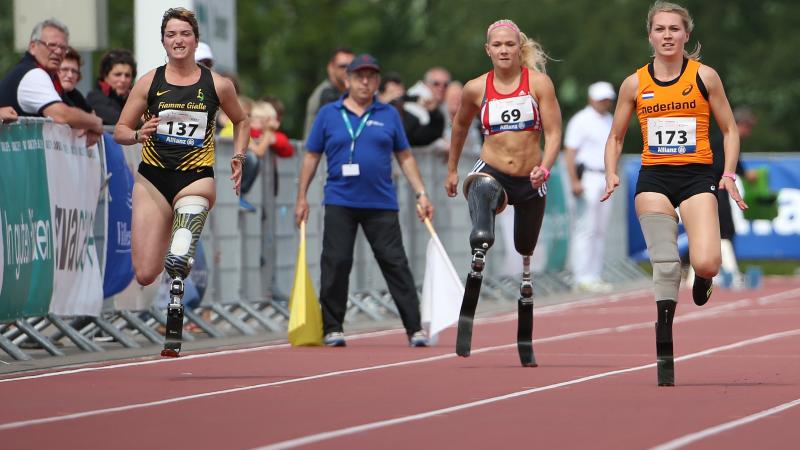 A group of female blade runners sprinting down the 100m straight.