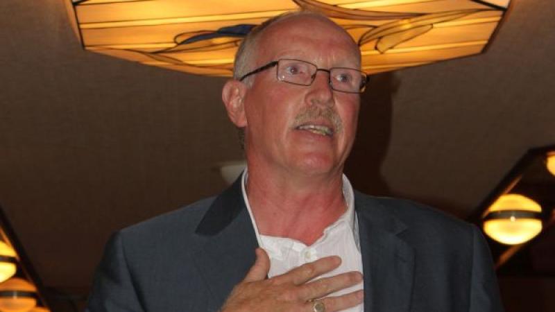 A man holding an award acceptance speech.