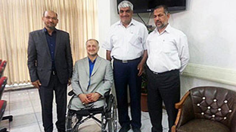 Four men pose together inside an office. 