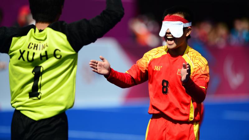 Blindfolded football player celebrates