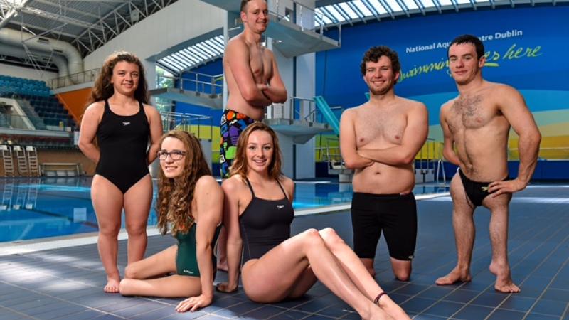 Group shot of swimmers in front of a pool