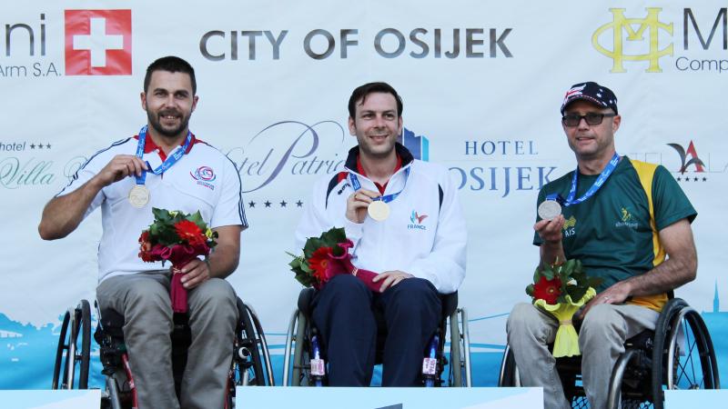 Three shooters display their medals at an IPC Shooting World Cup