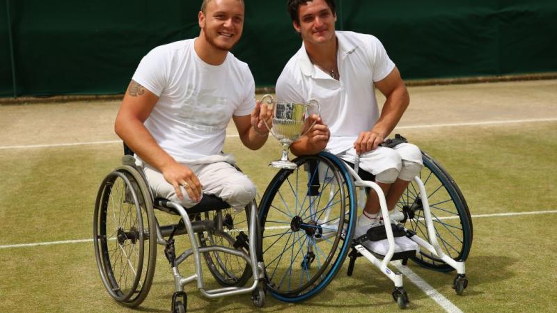 Nicolas Peifer of France and Gustavo Fernandez of Argentina pose with the winners trophy