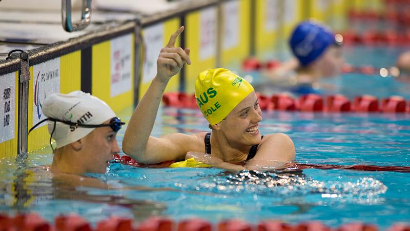 A swimmer celebrates a race win and world record