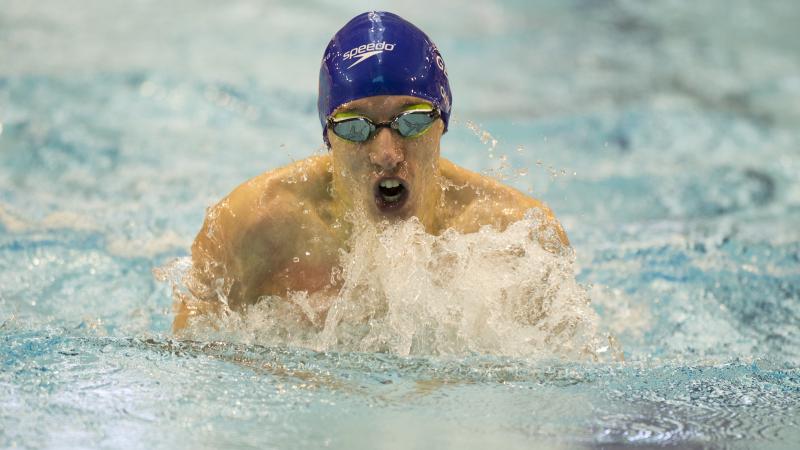 A Para swimmer competes in breaststroke