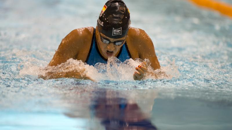 A swimmer competes in the breaststroke