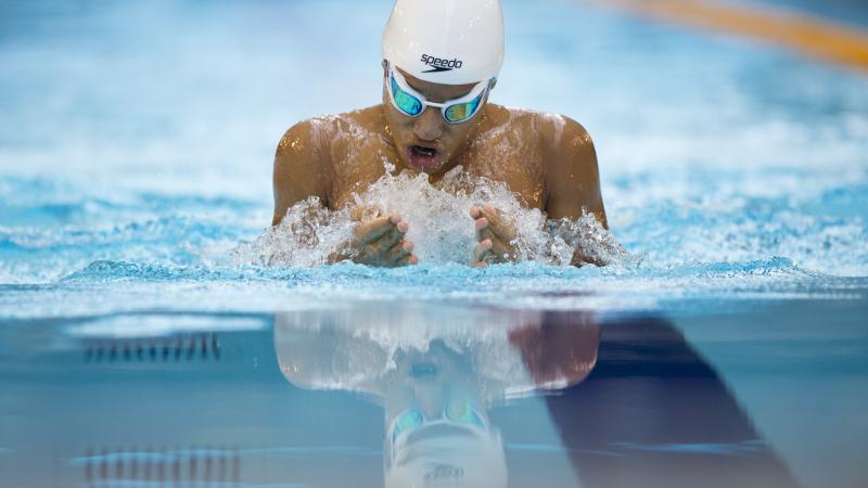 Swimmer in the water, doing breaststroke