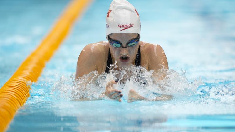 Woman in the pool swimming breaststroke